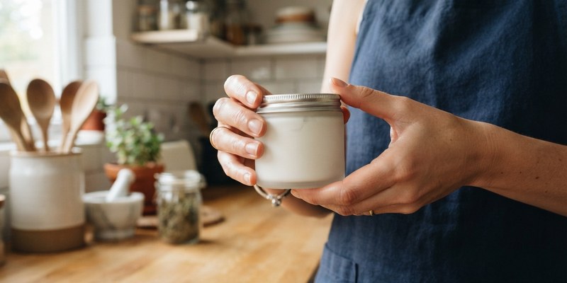 hands holding glass jar