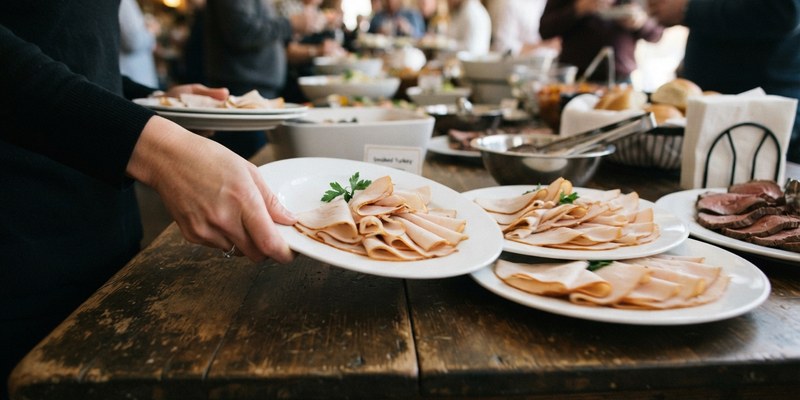 hand pushing turkey deli